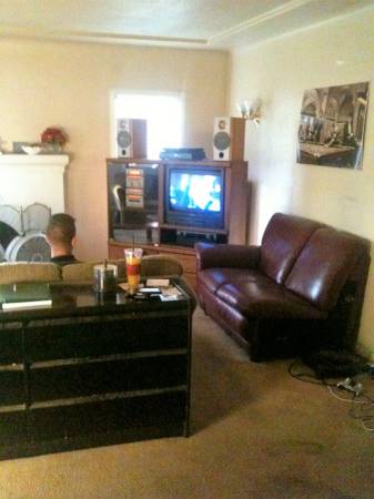 Large flat screen TV in the living room
               at Alpha Omega Sober Living.